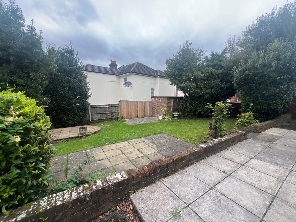 Lot: 35 - FORMER HOTEL FOR DEVELOPMENT POTENTIAL - rear garden with patio and lawn